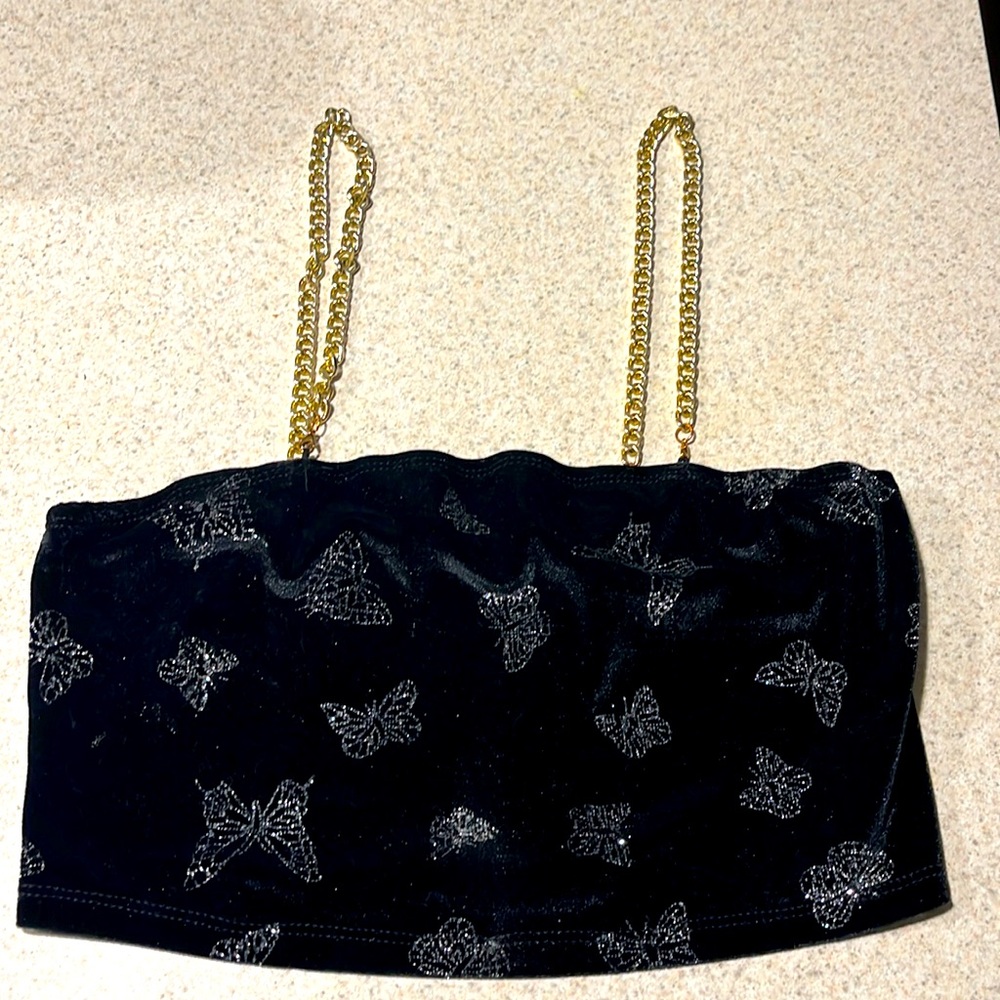 Front/Back it’s a soft black crop top with silver butterflies and gold chains